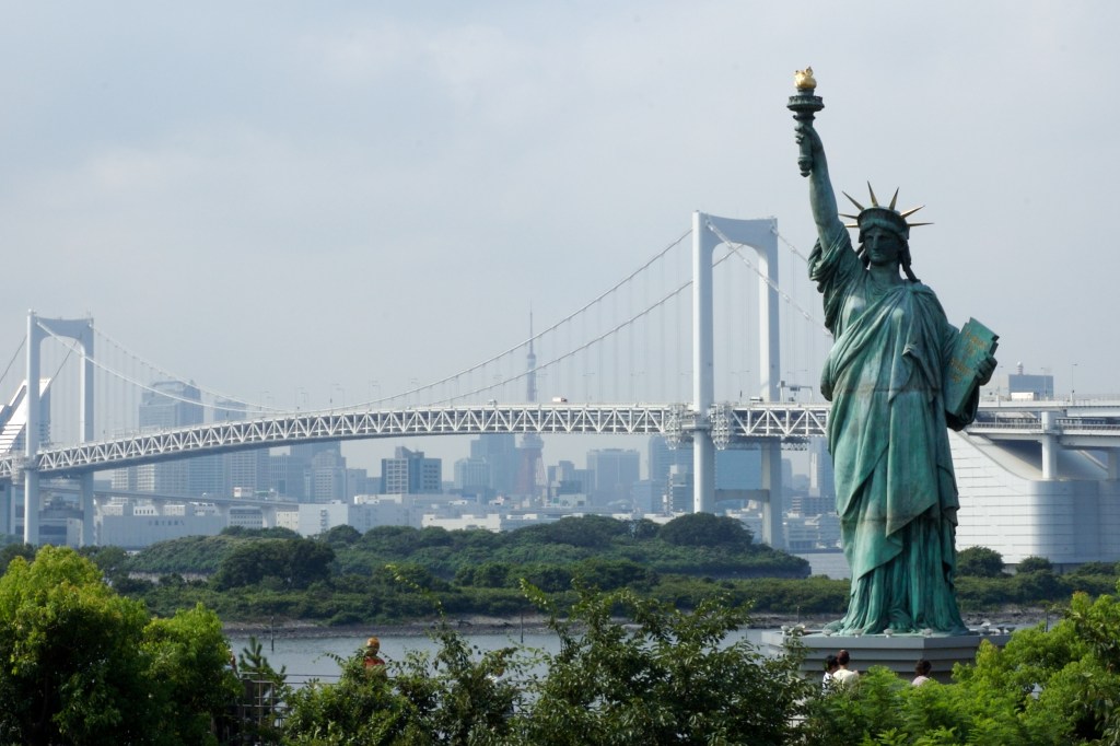 Japan’s replica of the Statue of Liberty with Tokyo Bay and the Rainbow Bridge in the background