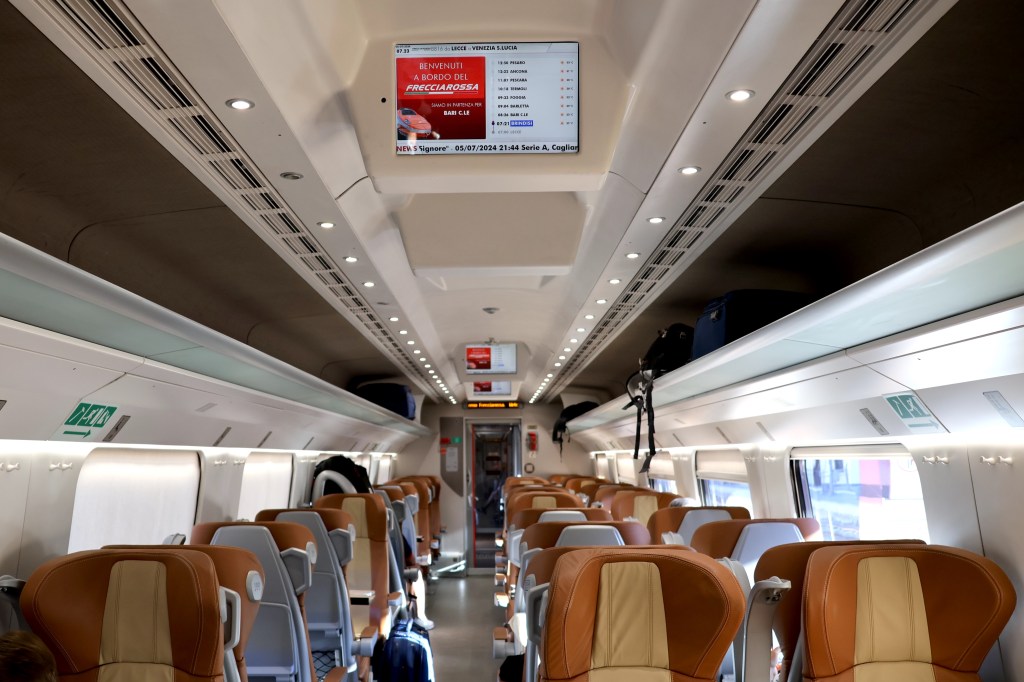 Real-time information about the journey is displayed on overhead screens in business class (coach 2) on the Frecciarossa ETR 600 high-speed train, 6 July 2024